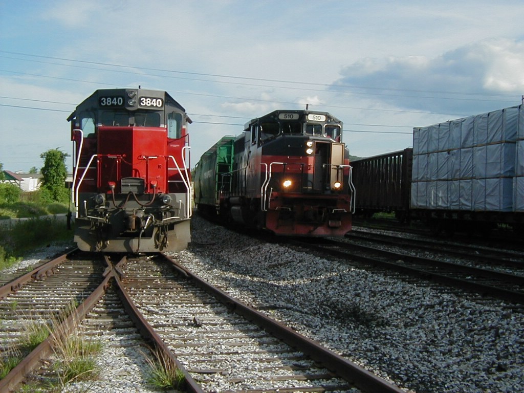 MEC 510, with just 3 hopper cars, passes parked NECR 3840